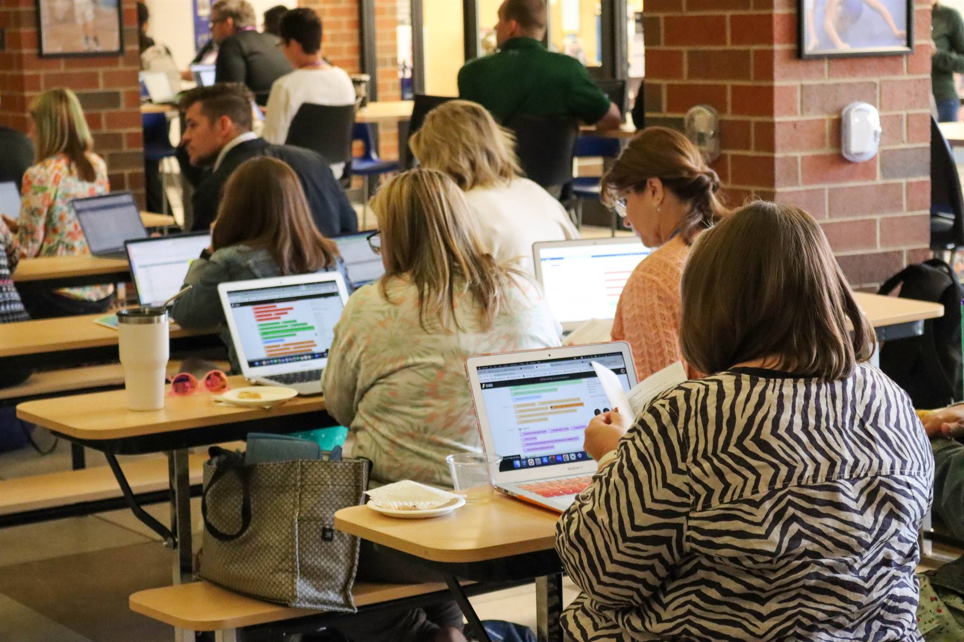 Attendees look at presentation on their laptops