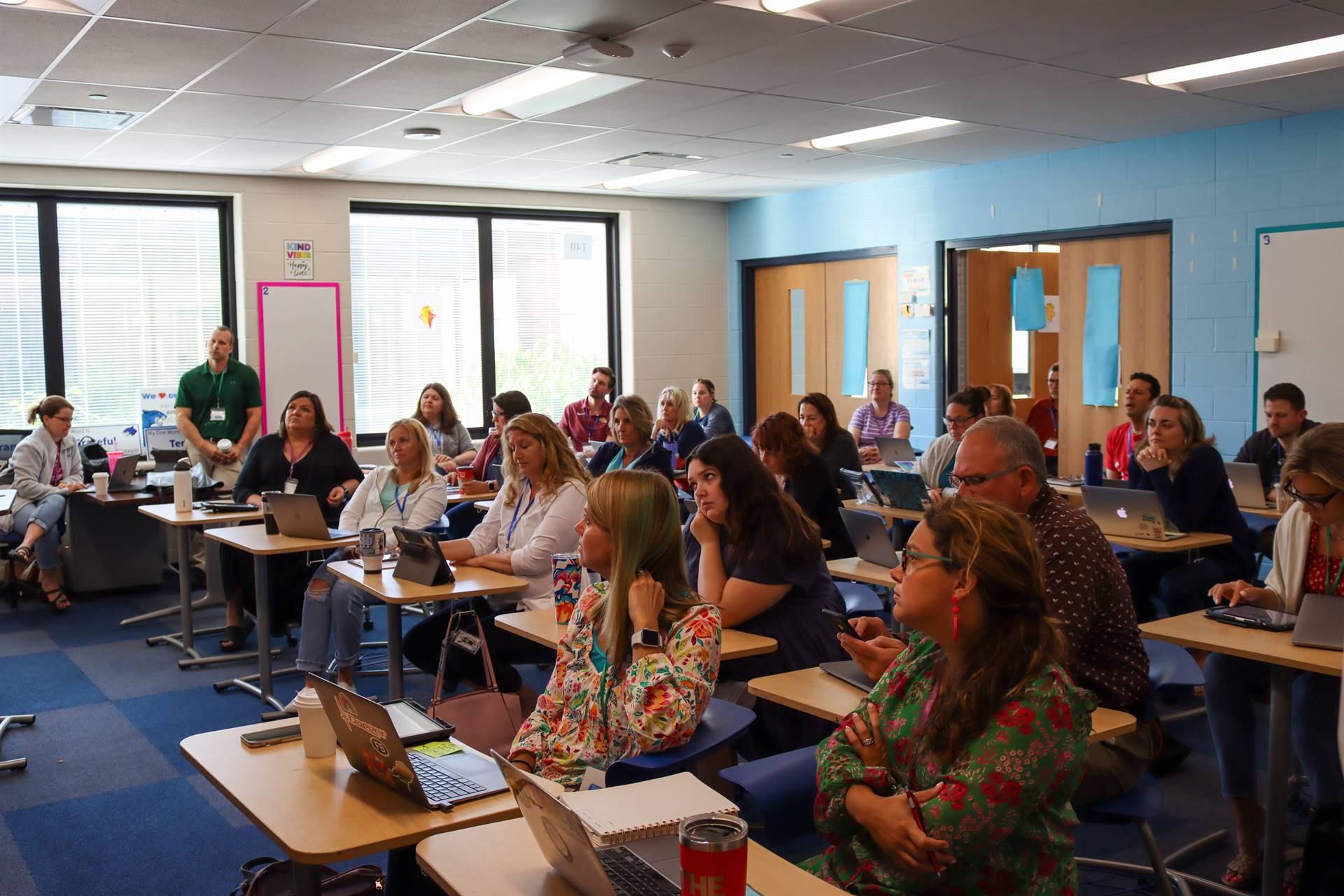 Attendees listen to session presenter